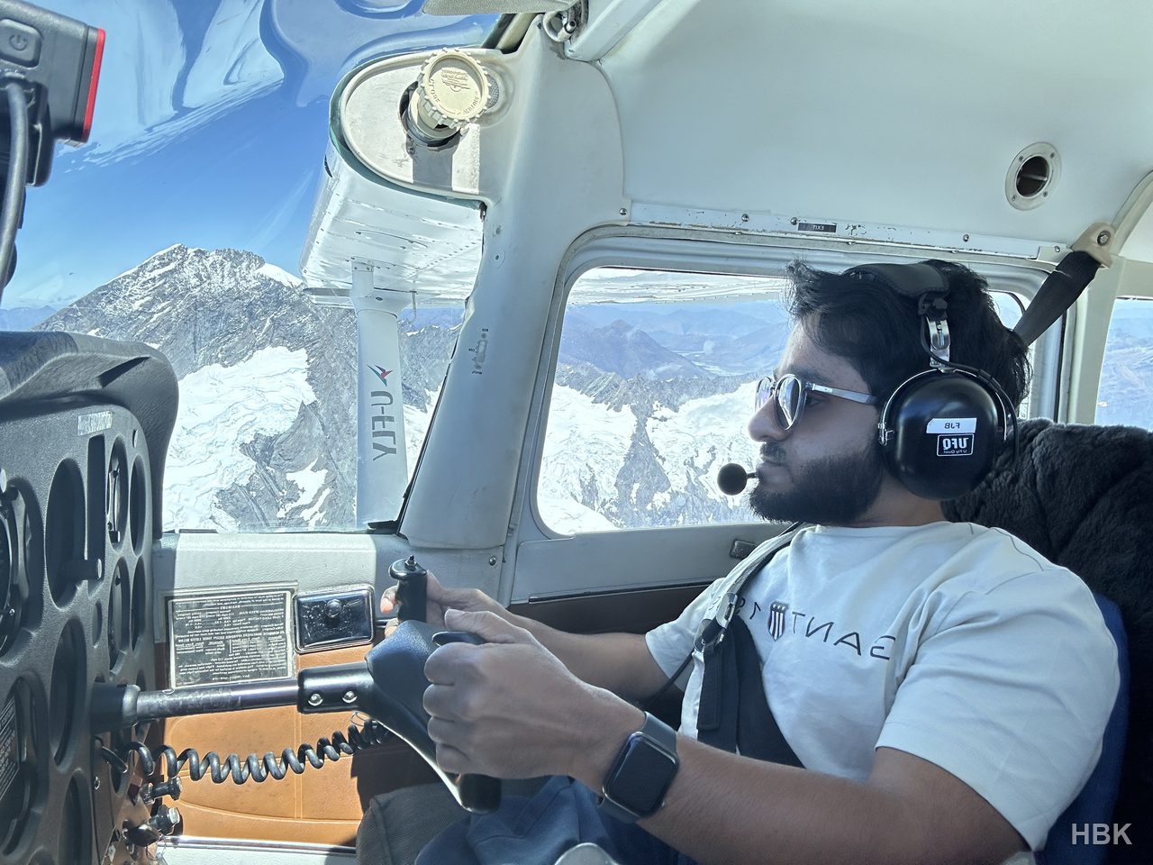 Naveed wearing a headset and holding aircraft controls